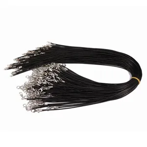 Macro view of black wax necklace cords with silver lobster clasps for DIY jewelry