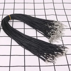 Close-up of black waxed necklace cords with silver lobster clasps for DIY jewelry
