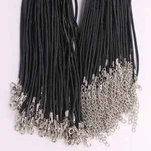 Detailed macro view of black wax necklace cords with lobster clasps and extension chains