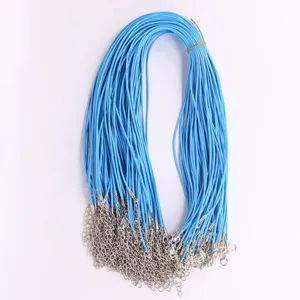 Detailed view of blue waxed DIY necklace cords with silver lobster clasps and chain extenders