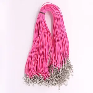 Detail view of bright pink wax necklace cords with silver lobster clasps and extension chains.