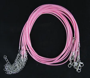 Close-up of pink wax cords for DIY necklace making with silver lobster clasps
