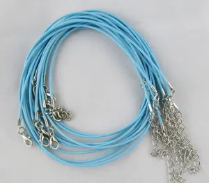 Close-up of light blue braided wax cords for DIY necklace making with silver clasps