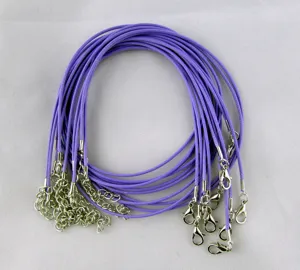 Detailed view of bundled purple waxed DIY necklace cords with silver lobster clasps.
