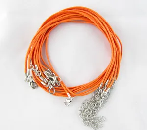 Close-up of orange waxed cord necklaces with silver lobster clasps and extension chains