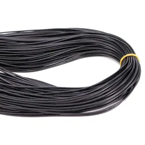 Macro detail of black braided wax cord for DIY jewelry making and handmade necklaces