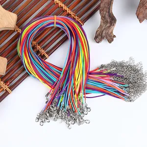 Detailed view of assorted colorful waxed necklace cords with lobster clasps and chains.