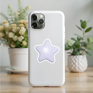 Detail view of a white phone case featuring a lovely 3D purple star sticker on a desk.