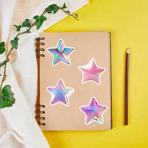 Close-up of shiny 3d star holographic stickers arranged neatly on a notebook for decor.