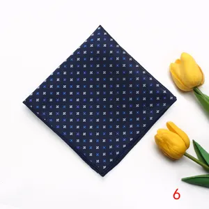Detailed view of dark blue pocket square with delicate white and blue floral pattern.