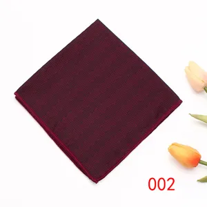Close-up detail view of the burgundy pocket square featuring delicate geometric herringbone patterns.