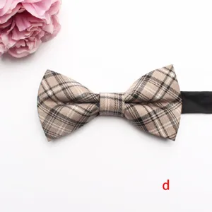 Detailed view of the classic beige plaid bow tie with black strap, shirt collar accessory.