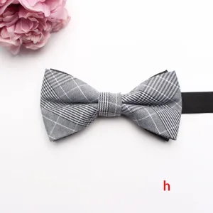 Detailed view of a classic black and white plaid bow tie with adjustable black strap.