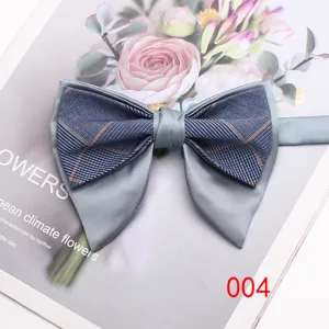 Detailed view of stylish double layer horn bow tie featuring grey fabric and classic plaid pattern.