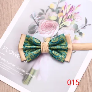 Close-up detail of a stylish blue and green paisley bow tie featuring champagne contrast panels.