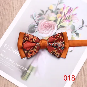 Close-up detail of stylish men's bow tie with orange satin and geometric patterned fabric.