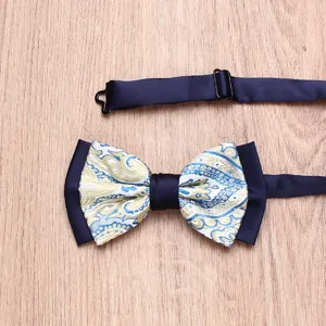 Elegant men's paisley bow tie with blue and gold pattern, adjustable strap for formal wear.
