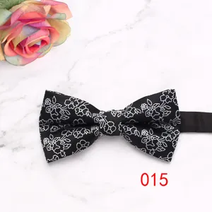 Men's black floral bow tie detail, elegant wedding suit accessory, classic formal necktie.