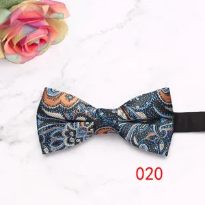 Close-up detail of the vintage paisley bow tie with intricate blue and orange patterns.