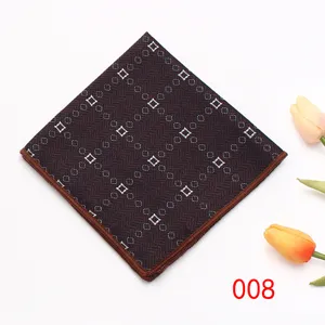 Close-up detail of dark brown geometric patterned pocket square with neat stitched edge.
