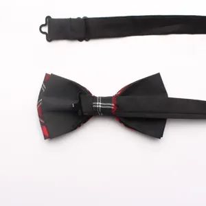 Detailed view of black and red plaid bow tie featuring an adjustable strap and buckle.