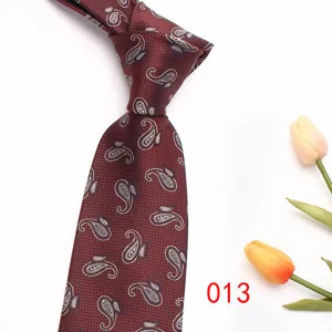 Detailed close-up view of a classic red paisley jacquard men's tie for business suits.