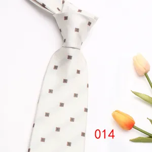 Detail view of a classy white business necktie with subtle square jacquard pattern and tulips.