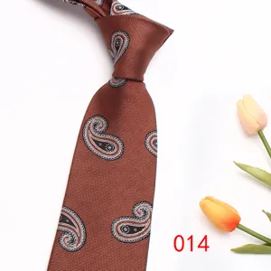 Close-up detail of brown classic paisley patterned men tie, exquisite woven texture design.