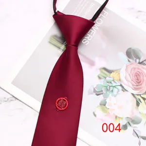 Detail view of a burgundy zipper necktie featuring a traditional double happiness charm.