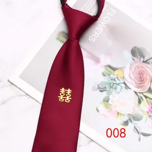 Detail shot of red wedding zipper necktie with golden double happiness symbol accent.