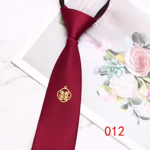 Wine-red wedding zipper necktie with gold double happiness emblem, elegant groom detail.