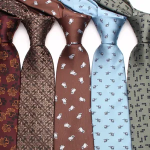 Detailed view of stylish printed mens neckties featuring floral, dog and helicopter patterns.