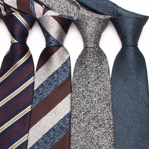 Men's classic necktie detail showcasing elegant patterned fabric and sophisticated textured design.