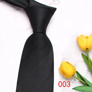 Detail view of a black business men's tie on marble background with tulip decor.