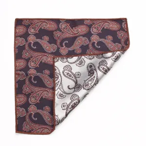 Dettaglio in primo piano di una classica pochette con motivo cachemire e bordi arrotolati.