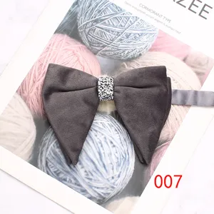 Dark grey velvet bow tie with sparkling rhinestone center knot, elegant suit accessory.