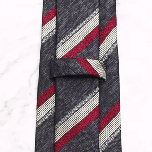 Detailed view of men's retro geometric striped polyester business tie with textured finish.