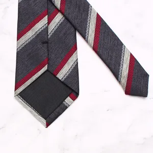 Close-up detail of mens business striped necktie, showing textured woven fabric and lining.
