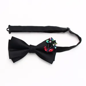 Black satin double layer bow tie featuring crystal flower embellishment detail close up view