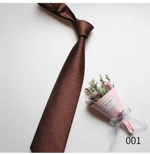 Detail view of brown patterned mens necktie, fine texture fabric for business formal wear.