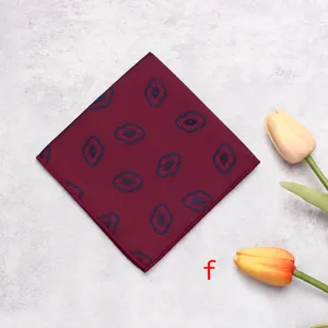 Detail view of a luxury burgundy pocket square featuring unique abstract patterns and fine edges.