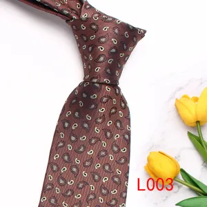 Brown paisley printed men's necktie detail view, elegant formal wear accessory for groom.