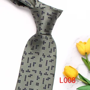 Men's stylish grey printed necktie with geometric block pattern, elegant formal accessory.