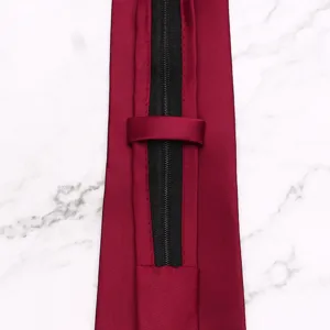 Detail shot of a wine red zipper necktie, showing the easy-to-wear pre-tied mechanism clearly.