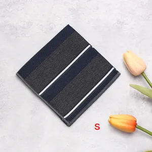 Detail view of the elegant striped pocket square on textured background with tulip decor.