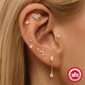 Makroaufnahme von vergoldeten Sterling Silber Stern und Schmetterling Knorpelpiercings