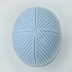 Top view of light blue ribbed knit beanie hat showing neat crown stitching details