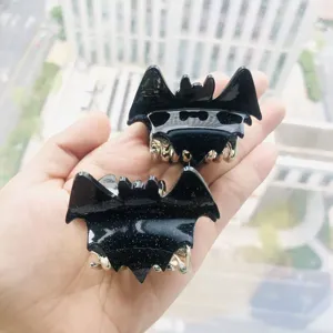 Fashionable bat-shaped hair claw clips with black glitter finish and gold metal teeth