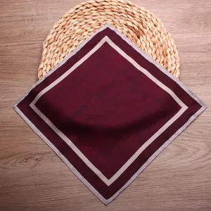 Burgundy pocket square with beige border detail, elegant silk handkerchief for men's suit jacket.