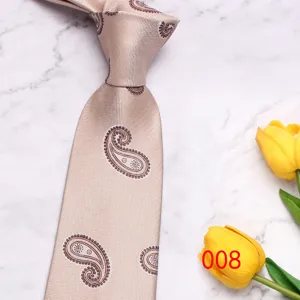 Classic beige paisley necktie detail shot showing fine textured fabric and elegant pattern.